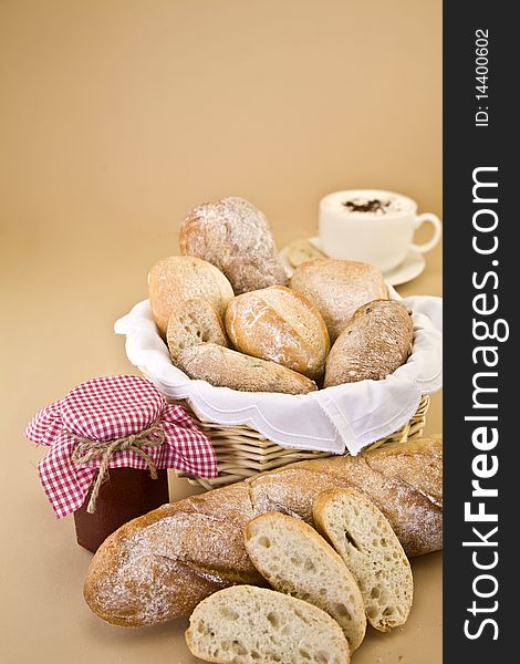 Assortment of bread with jam and coffee against a beige background. Assortment of bread with jam and coffee against a beige background.