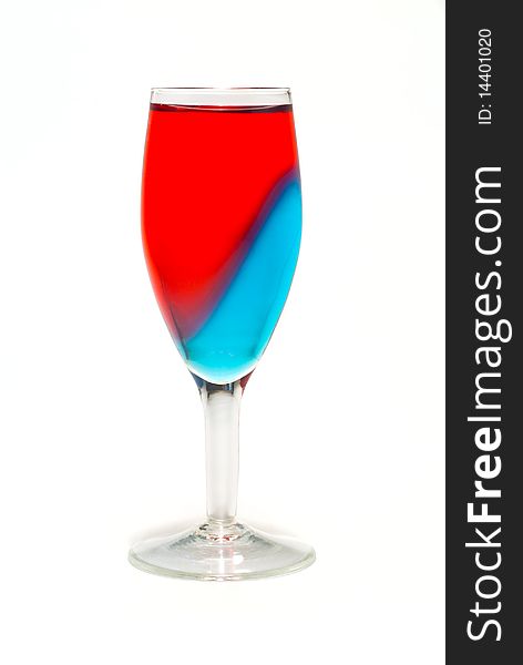 Glass with sliced red and blue cocktail. Isolated on white
