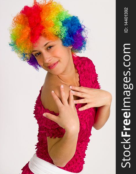 A portrait of a girl in a clown wig, posing playfully. A portrait of a girl in a clown wig, posing playfully