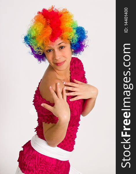 A portrait of a girl in a clown wig, posing playfully. A portrait of a girl in a clown wig, posing playfully