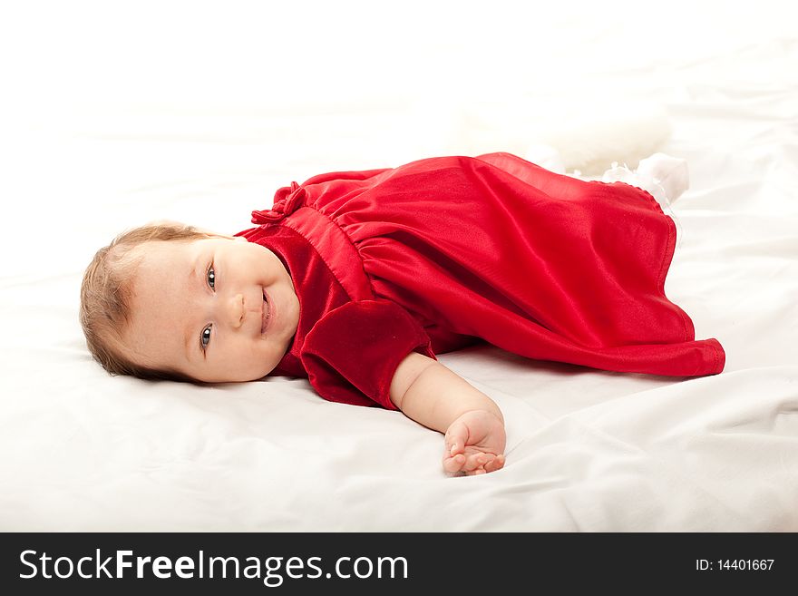 Cute baby girl in beautiful red dress
