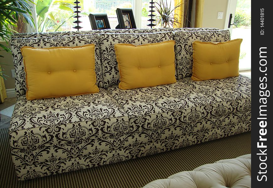 Beautiful black and white couch or sofa with three yellow gold pillows. Beautiful black and white couch or sofa with three yellow gold pillows