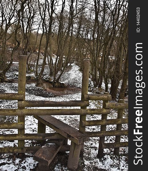 Woodland staffordshire forest walk and stile in winter snow. Woodland staffordshire forest walk and stile in winter snow