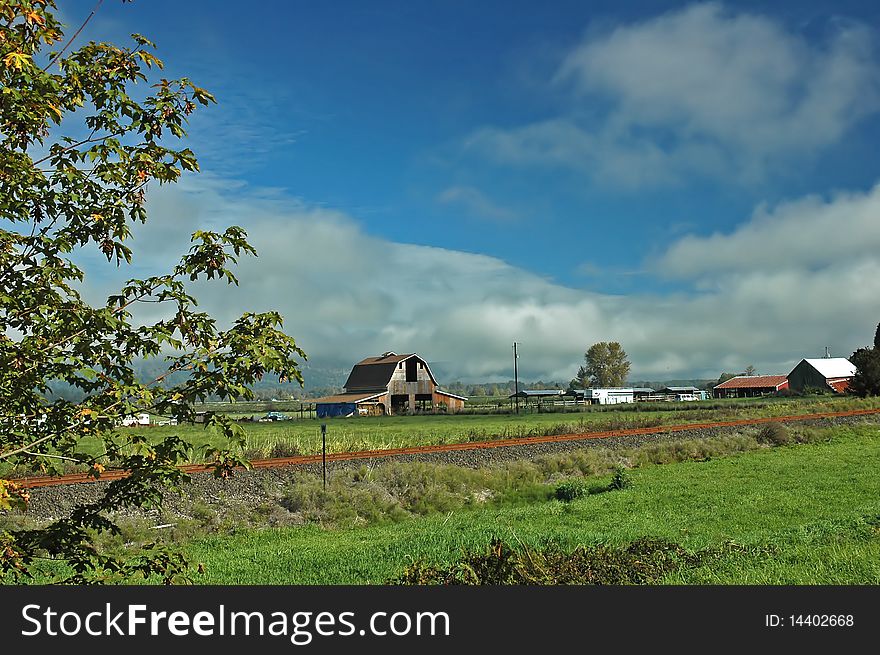 A barn and several outbuildings make up a 
farm scene