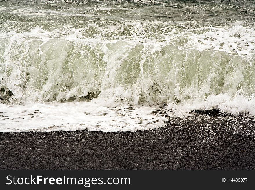 Heavy waves with white wave crest in storm at the beach from Janubio, a volcanic black beach, Lanzarote, Spain