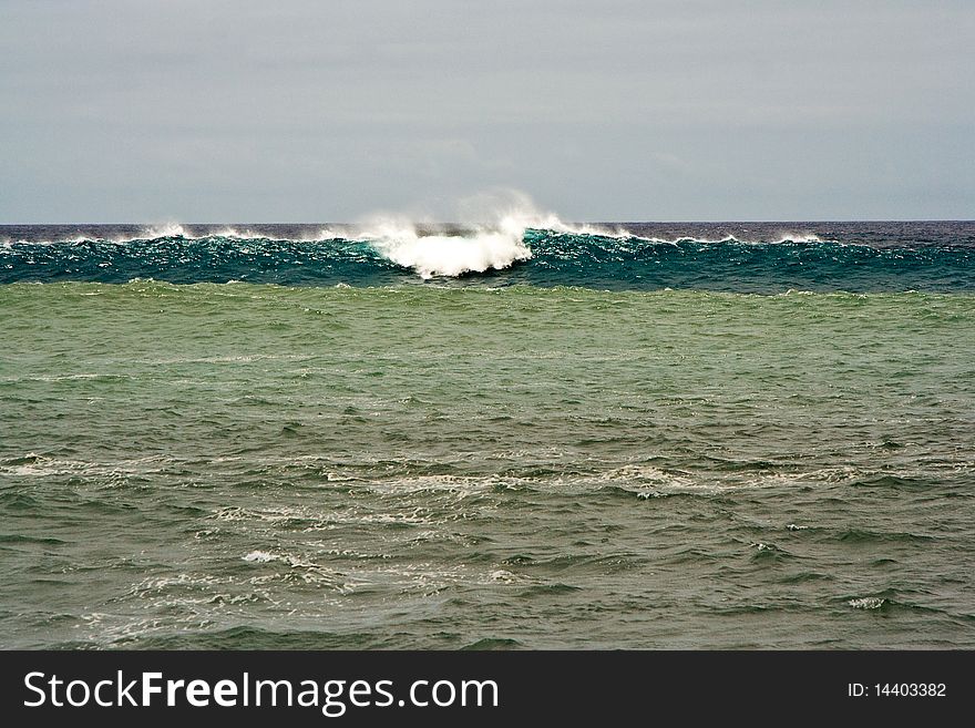 Heavy waves with white wave crest in storm at the beach from Janubio, a volcanic black beach, Lanzarote, Spain