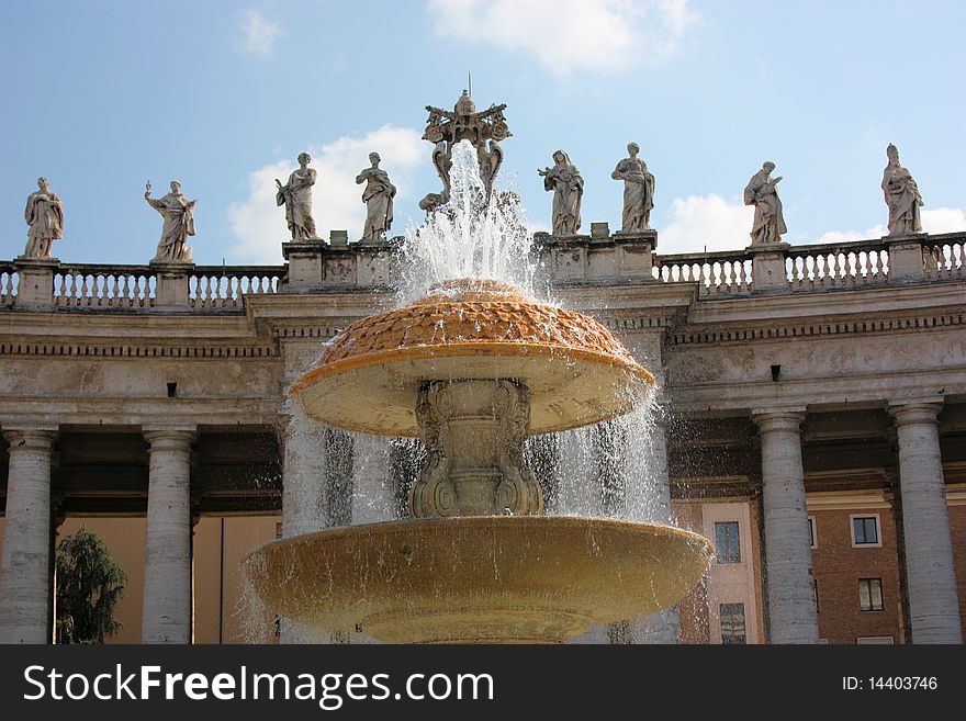 A view of a Vatican City fountain in Saint Peterâ€™s Square by Maderno with statues of saints and martyrs in the background