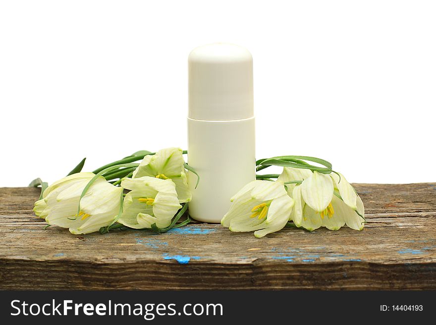 Spa cosmetic bottle and flower on a wooden board isolated. Spa cosmetic bottle and flower on a wooden board isolated