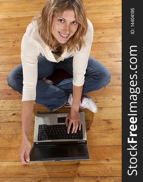 Young smiling woman with laptop computer. Top view