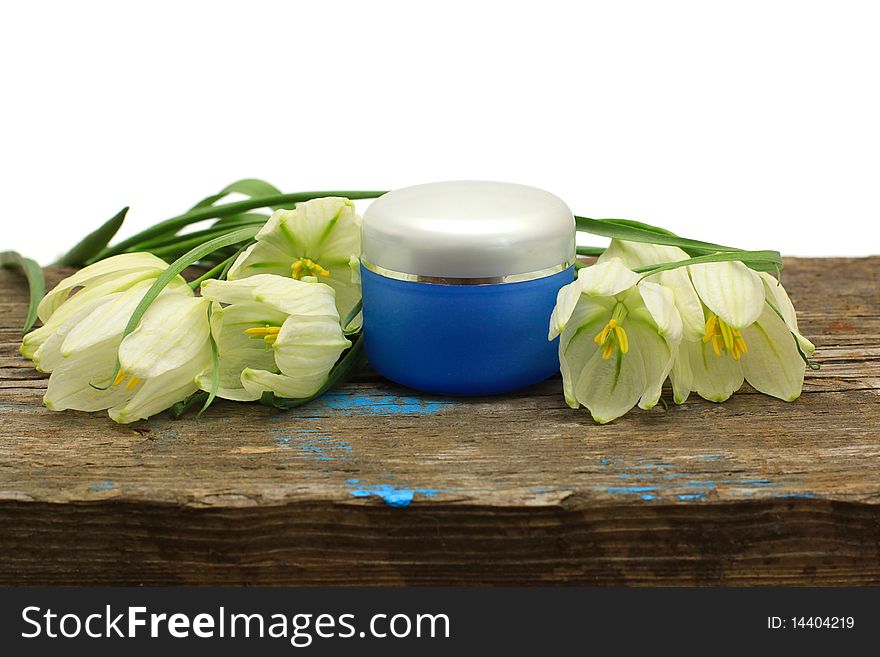 Spa cosmetic bottle, flower and wooden board isolated on white background