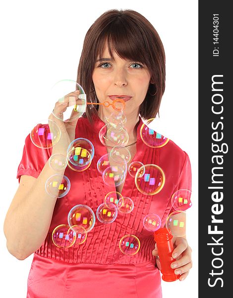 Cheerful woman starts up soap bubbles on a white background