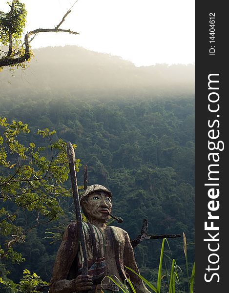 A statue of a Taiwanese aboriginal looks out across the mountains, in Wulai, Taiwan. A statue of a Taiwanese aboriginal looks out across the mountains, in Wulai, Taiwan