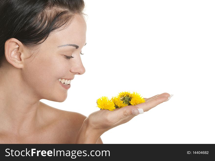 Smiling woman holds yellow flowers on palm