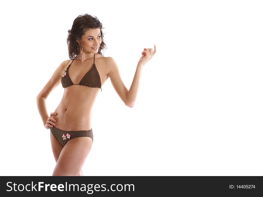 A young and attractive female in a brown swimsuit. Image isolated on a white background.