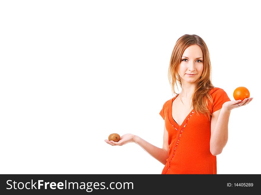 Picture of a young pretty girl in dress which holds orange and kiwi in different hands. Isolated on white. Picture of a young pretty girl in dress which holds orange and kiwi in different hands. Isolated on white.