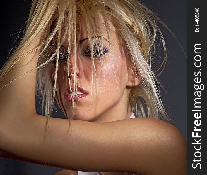 Passionate woman fluffing up blond hair