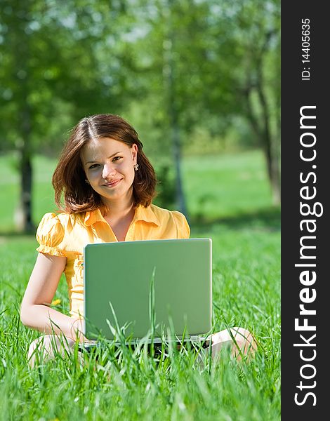 Young sweet girl working with laptop outdoor
