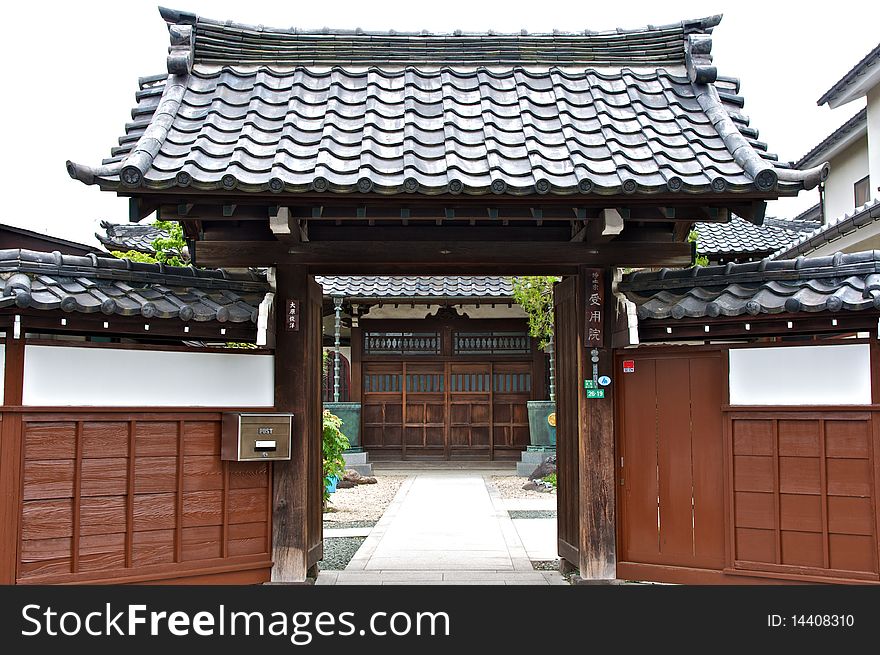 The exterior of a Shinto temple with dark colored wood walls. The exterior of a Shinto temple with dark colored wood walls