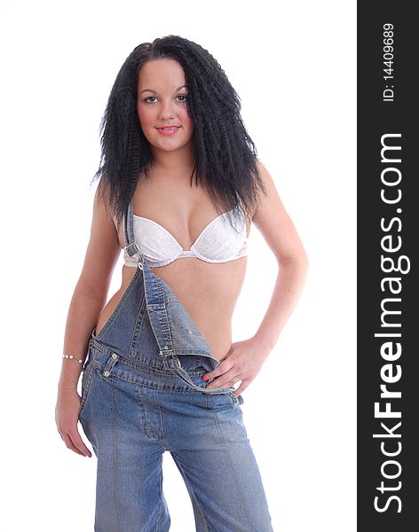 Photograph of pretty girl in bra and dungarees isolated