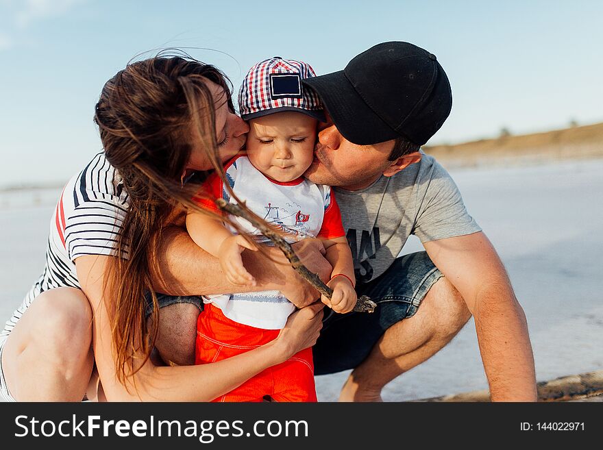 Funny portrait of a happy family on the beach