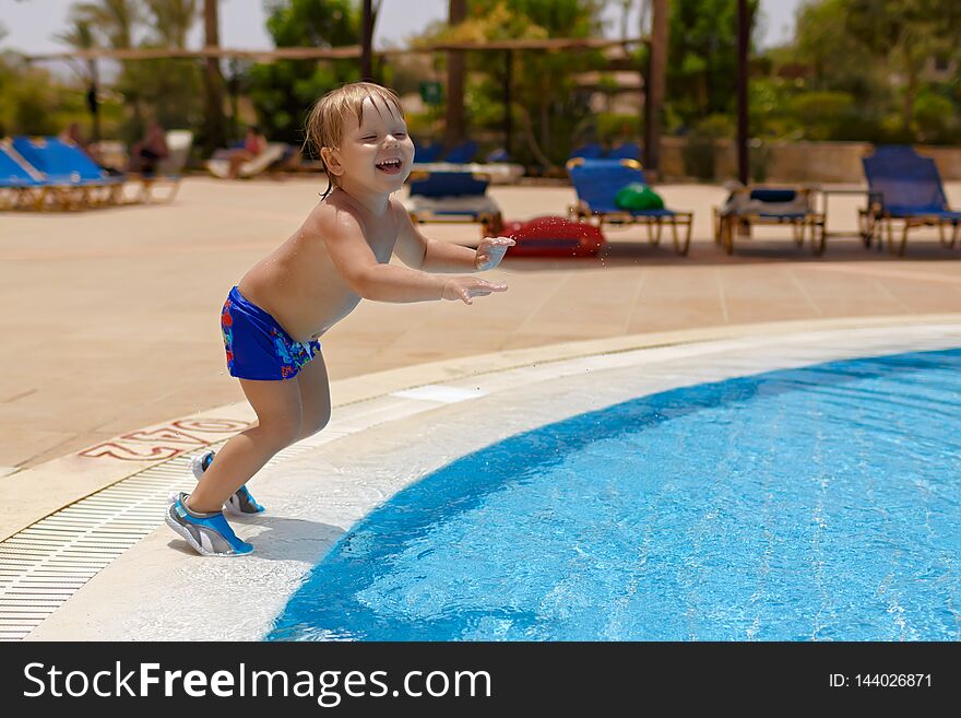 Excited Blond-haired Child Boy Going To Jump Into The Swimming Pool