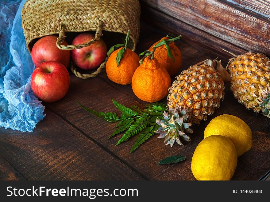 Background from many different exotic fruits. Healthy foods, pineapple, mango, apples, tangerines.