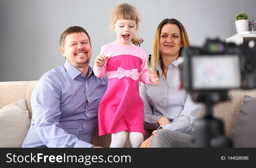 Young happy family sit on couch making photo session portrait