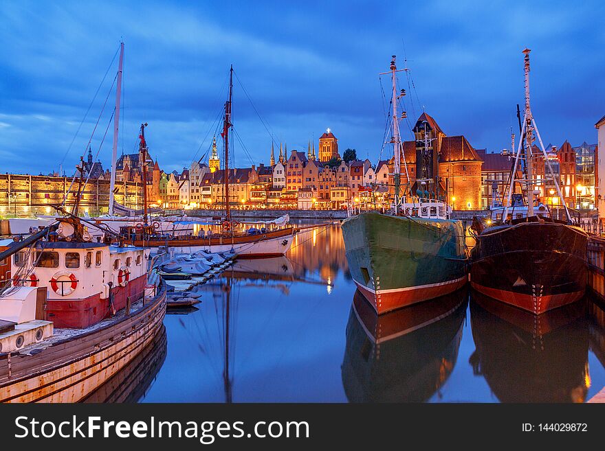 Multi-colored facades and boat on the central waterfront in Gdansk at night. Multi-colored facades and boat on the central waterfront in Gdansk at night.