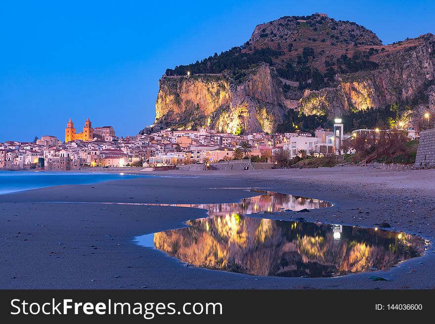 Beautiful panoramic view of the beach and old town of coastal city Cefalu during evening blue hour, Sicily, Italy. Beautiful panoramic view of the beach and old town of coastal city Cefalu during evening blue hour, Sicily, Italy