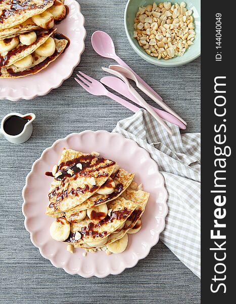 Delicious pancakes with fresh banana and chocolate sauce