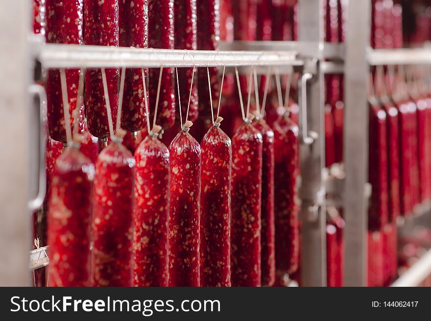 Salami Production. Sausage Production Line. Sausage On The Counter For The Smokehouse