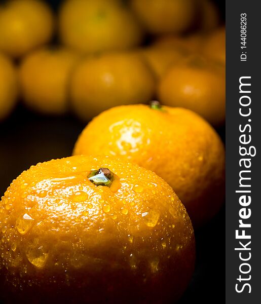 Water droplet on glossy surface of freshness orange on black background