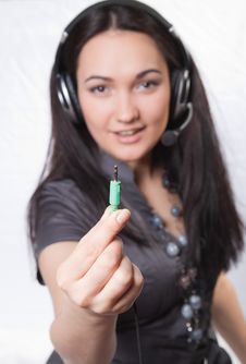 Young Woman With Headphones And Jack Plug In Hand Stock Photo Young Woman With Headphones And Jack Plug In Hand Stock Photo