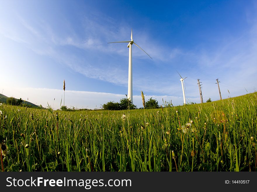 Wind turbine on the meadow shown by fisheye lens. Wind turbine on the meadow shown by fisheye lens