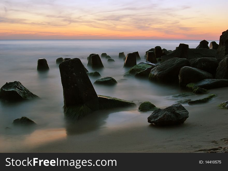 Sea water stones clouds sand