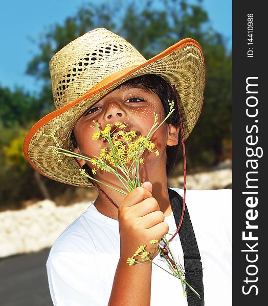 Portrait of a happy young beautiful boy smelling flowers. Portrait of a happy young beautiful boy smelling flowers