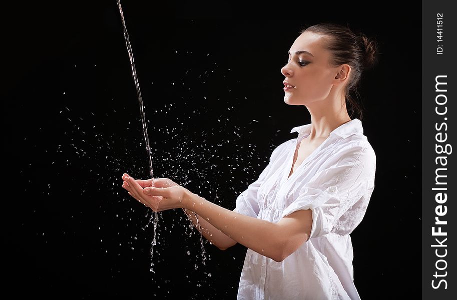 The girl hands catching a water stream