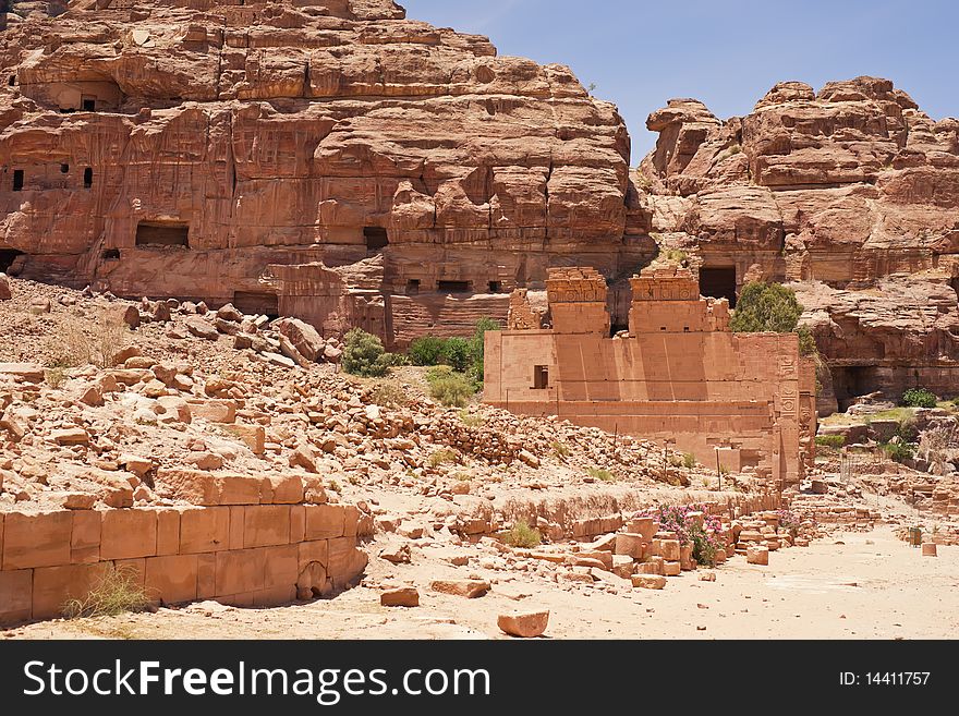 Wide view of cliff side tomb carved from the beautiful richly-colored sandstone in the ancient city of Petra, Jordan. Wide view of cliff side tomb carved from the beautiful richly-colored sandstone in the ancient city of Petra, Jordan