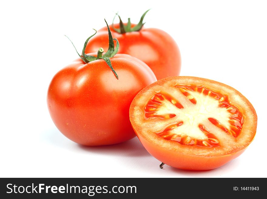 Red tomato vegetables with a half isolated on white background