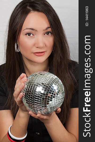 Portrait of pretty young woman with mirror ball