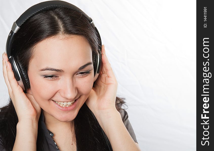 Studio portrait of happy beautiful girl listening music