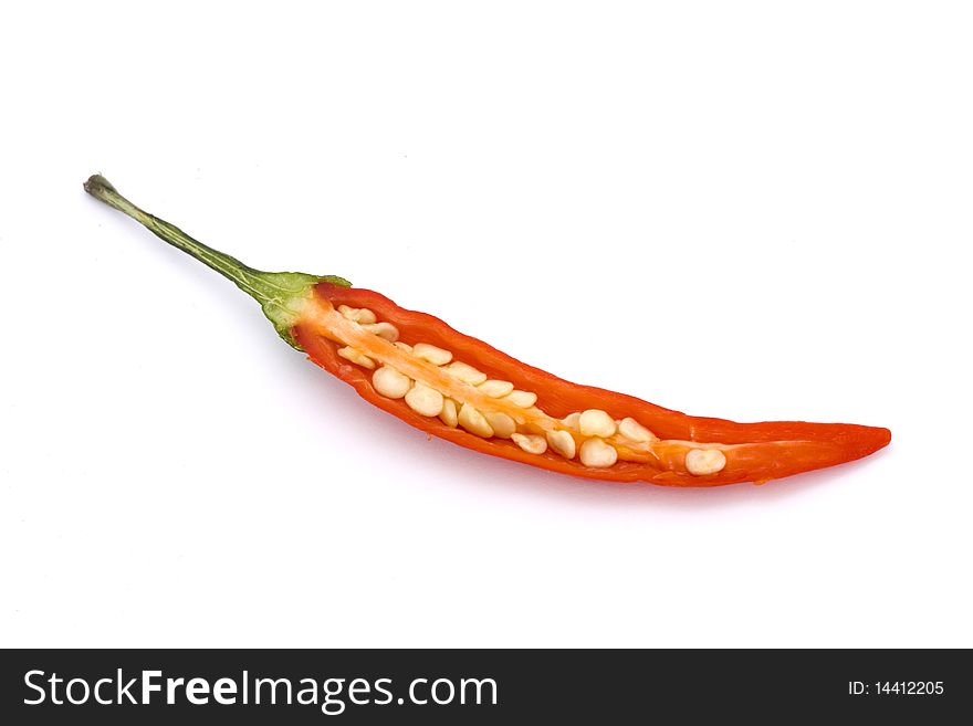 Cut open red birds eye chilli on a white background. Cut open red birds eye chilli on a white background
