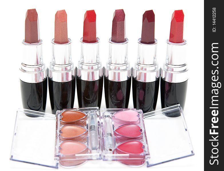 Lipstick stands in row and openning box with make-up on white background