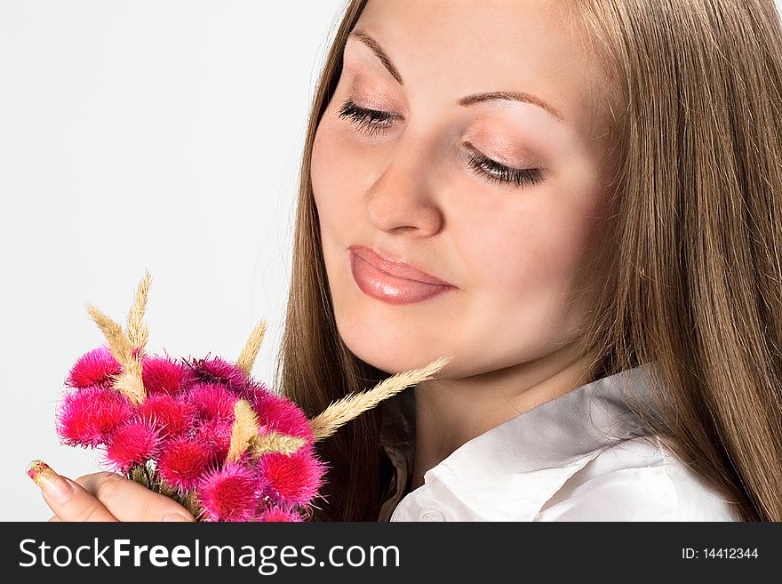 Woman portrait with red flower over gray background. Woman portrait with red flower over gray background