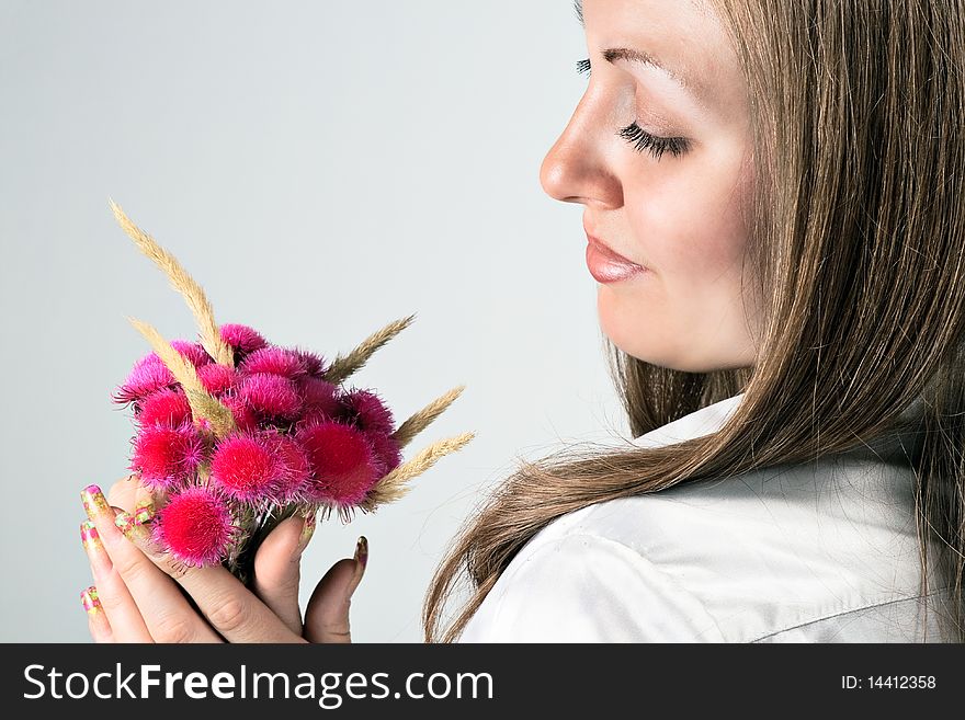 Beauty portrait of a young woman with a red flower. Beauty portrait of a young woman with a red flower