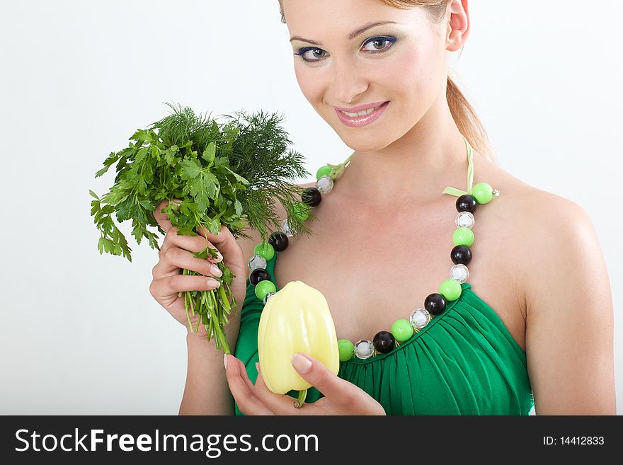 Beautiful young girl holding a Bulgarian pepper an