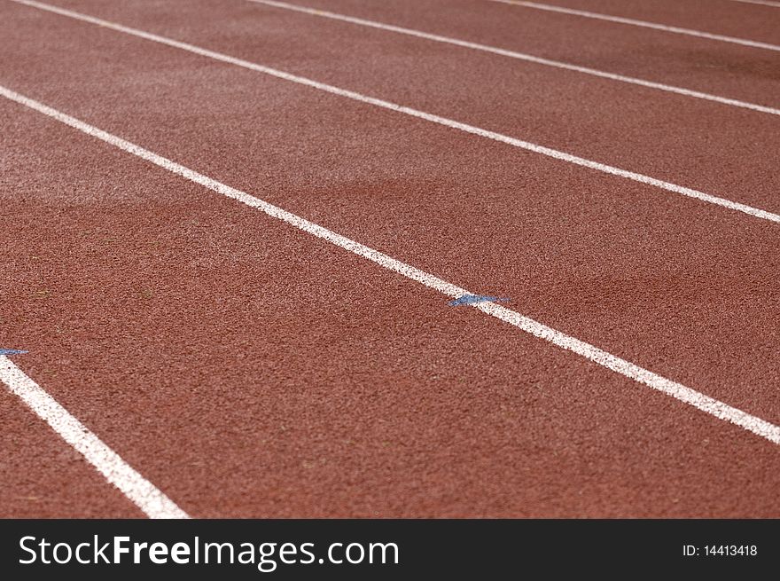 Red running track with white lane markings