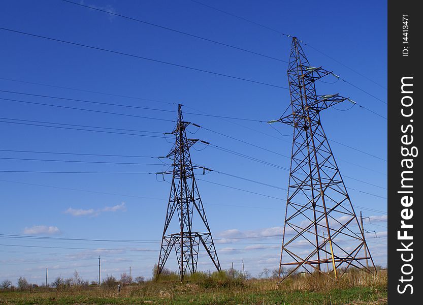 In the field there are two support of high-voltage lines