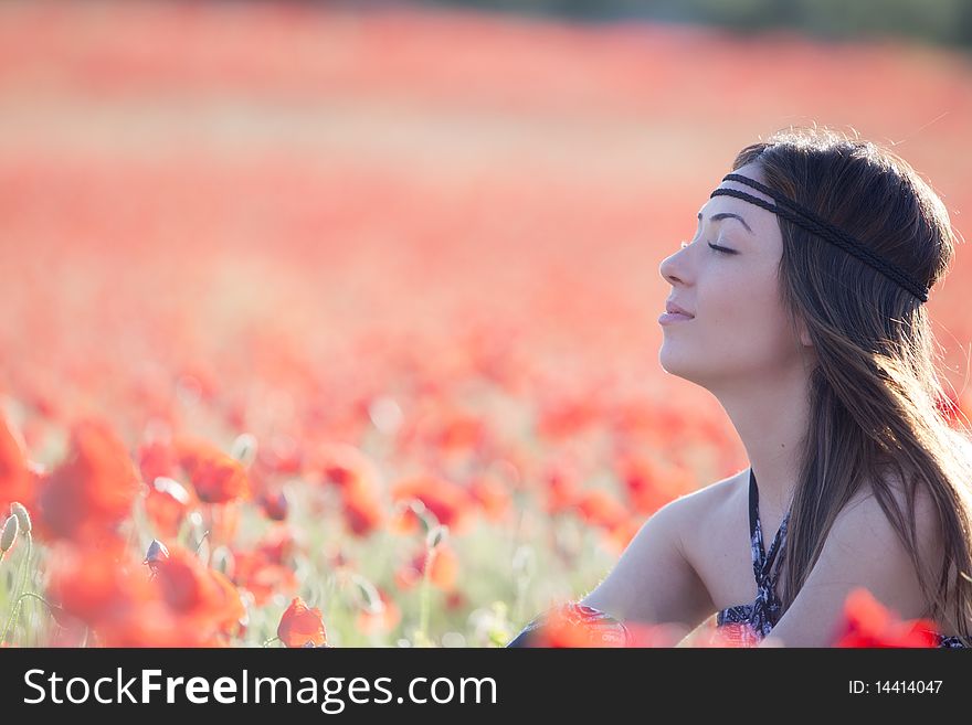 Young relaxed adult with closed eyes in a poppies field. Young relaxed adult with closed eyes in a poppies field.