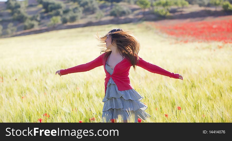 Young girl feeling freedom in green field. Young girl feeling freedom in green field.